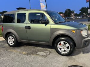 Green Honda Element parked outside, showcasing its compact design and clean exterior, relevant to Steve's Pit Stop Mobile Mechanic's automotive services.