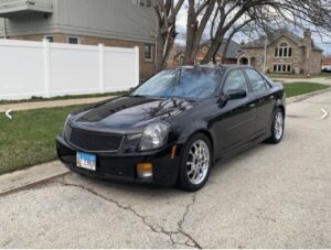 Black Cadillac CTS parked on a residential street, showcasing sleek design and alloy wheels, relevant to Steve's Pit Stop Mobile Mechanic's auto repair services.